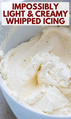 a white bowl filled with whipped cream on top of a table