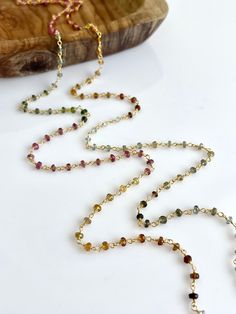 Long Tourmaline Necklace, Watermelon Tourmaline Beaded Necklace, October Birthstone, Multicolor Layering Necklace, Gold Rosary, Gift for her Watermelon Tourmaline Beaded Long Necklace. Wire wrapped in 14k gold filled.  Rondelle size is 3 mm Total Necklace length is 36 inches and closes with a lobster clasp.  **Shorter lengths available upon request** Gift Wrapping included in all orders Handmade in our home studio Wear this necklace long or doubled up. IMPORTANT: In order to double this necklace you must open the clasp. It will NOT go over the head without opening.  Processing time: 1 Day Please visit my full collection of LONG NECKLACES: https://www.etsy.com/shop/YaniaJewelry?ref=l2-shopheader-name&section_id=13344426 Please visit my full collection of NECKLACES: https://www.etsy.com/shop Tourmaline Beaded Necklaces For Jewelry Making, Elegant Tourmaline Beaded Necklaces, Multicolor Tourmaline For Jewelry Making, Tourmaline Beaded Necklace For Gift, Tourmaline Single Strand Necklace With Round Beads, Multicolor Tourmaline Beaded Necklace With Faceted Beads, Bohemian Multicolor Tourmaline Necklaces, Multicolor Tourmaline Gemstone Beads Necklaces, Multicolor Beaded Tourmaline Jewelry