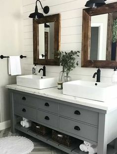 a bathroom with two sinks and mirrors on the wall