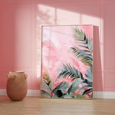 a vase sitting next to a painting on the wall in a room with pink walls