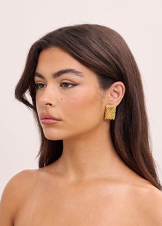 The Emery Earring is a versatile and stylish earring that can effortlessly elevate any outfit. Its bold texture and lightweight design make it comfortable to wear from day to night. Add a touch of elegance to your look with the Emery Earring. 16K Gold Filled lightweight Hypoallergenic Posts Height 3cm x Width 2cm Elegant Textured Jewelry For Party, Chic Huggie Earrings For Formal Occasions, Elegant Textured Gold Plated Earrings, Chic Textured Gold Earrings, Elegant Textured Formal Earrings, Chic Yellow Gold Clip-on Earrings For Evening, Modern Textured Gold Earrings, Chic Clip-on Earrings In Yellow Gold, Chic Clip-on Yellow Gold Earrings