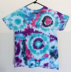 This far-out design features shades of purple, green, pink, black and blue all mingling in a trippy bull's eye effect. This product is guaranteed to be a 100% unique one-of-a-kind creation, hand-dyed at home in the US of A.  Al of our shirts come pre-washed and pre-shrunk, ready to rock and roll!  This shirt is READY TO SHIP!  This item is a unique, guaranteed one-of-a-kind so you don't have to worry about the fashion disaster of running into someone with the exact tee-shirt same design! ;) Thes Bohemian Tie Dye T-shirt For Festivals, Pink Short Sleeve T-shirt For Festivals, Hippie Tie Dye T-shirt For Festivals, Boho Swag, Diy Tie Dye Techniques, Tie Dye Techniques, Float Your Boat, Tie Dye Diy, Rave Festival