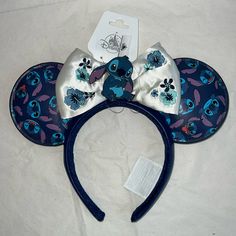 a blue and white minnie mouse ears headband with an image of stitching on it