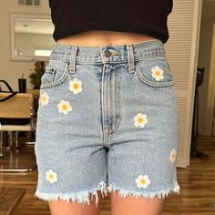 a woman wearing shorts with flowers on them