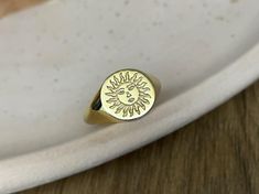 gold sun signet ring ♡ this beautifully engraved signet ring is a delicate piece of jewelry  to wear with any combination. the ring has solid back the face of the ring is 11 mm round materials: 10k gold 14k gold 14k rose gold 14k white gold 925 sterling silver 14k gold plated over silver 14k rose gold plated over silver gold/rose gold plated is genuine 925 sterling silver that has been expertly plated with a thick layer of 14k gold/rose gold size: we offer sizes from 3 to 13 1/2 for bigger size requests, please send a message ♡ important note about the ring size: ♡ to be able to make a ring which fits perfectly we kindly ask you to double check your finger size as shown in the picture in our gallery before placing your order shipping: ♡ all our listings include free expedited shipping deli Gold Celestial Signet Ring Stamped 14k, Celestial Gold Signet Ring Stamped 14k, Celestial Yellow Gold Signet Ring Gift, Celestial Style Yellow Gold Signet Ring Gift, Gold Celestial Engraved Ring As Gift, Celestial Style Gold Signet Ring As Gift, Gold Rings With Sun Design As Gift, Gold Rings With Sun Design For Gift, Symbolic Gold Rings With Sun And Moon Design