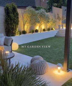 an outdoor living area is lit up at night with candles on the ground and lights in the grass