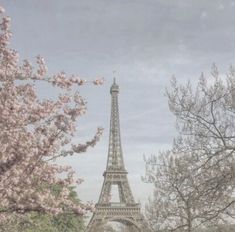 the eiffel tower is surrounded by trees and flowers