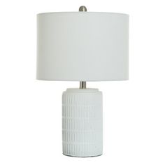 a white table lamp with a white shade