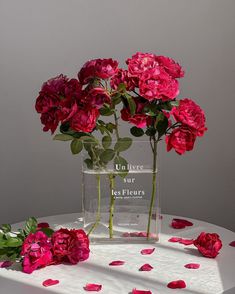 pink flowers in a clear vase on a table