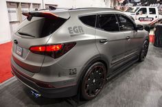 the rear end of a silver car on display