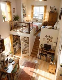 an aerial view of a living room and bedroom from the second floor, looking down