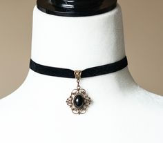 Elevate your style with our Black Velvet Choker with Black Agate Pendant. This stunning piece combines the elegance of black velvet with the natural beauty of a black agate stone, creating a versatile accessory perfect for any occasion. Product Features: Material: Luxurious black velvet ribbon and polished black agate stone Pendant Size: Approximately 1.5 inches in height Choker Length: Adjustable from 12 to 14 inches to fit comfortably Closure: Secure lobster clasp with extender chain Style: Go Gothic Boho, Black Agate Stone, Black Velvet Ribbon, Velvet Choker Necklaces, Crystals Necklace, Floral Filigree, Black Velvet Choker, Raw Crystals, Vintage Choker