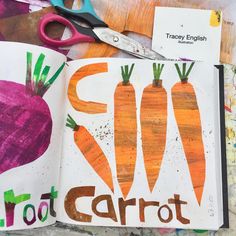 an open book with carrots drawn on it next to scissors and other art supplies