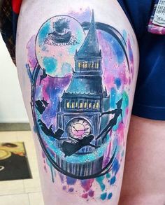 a person with a tattoo on their leg that has a clock tower in the middle