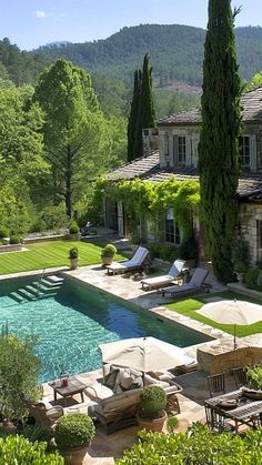 an outdoor swimming pool surrounded by greenery