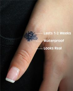 a woman's finger with an insect tattoo on it and the words, last 1 - 2 weeks waterproof looks real