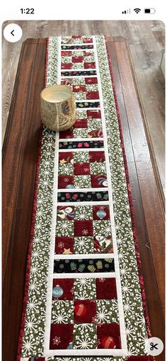 a table runner made with red and green quilts on top of a wooden table