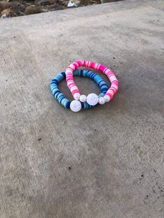 Just two regular pink and blue bracelets! Pink Stretch Bracelet For Beach, Pink Bangle Bracelet For Beach, Pink Bangle Bracelets For Beach, Pink Bracelet Wristband For Beach, Blue Bracelets, Clay Bead, Bead Bracelets, Blue Bracelet, Clay Beads