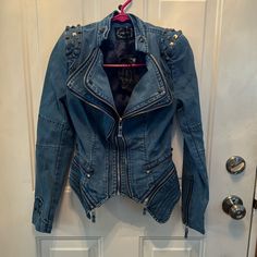 Shalang Studded Jean Jacket. Nwt. Lots Of Studs And Zippers. Never Worn. Blue Denim Jacket With Zipper For Fall, Fitted Denim Biker Jacket With Long Sleeves, Fitted Long Sleeve Denim Biker Jacket, Denim Biker Jacket For Fall, Fitted Blue Biker Jacket For Spring, Fitted Blue Biker Jacket With Long Sleeves, Studded Jean Jacket, Studded Jeans, Denim Corset