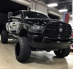 a large black truck parked in a garage