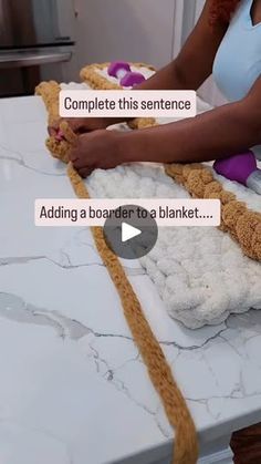 a woman is making stuffed animals out of blankets on a counter top with the caption, complete this sentence adding a border to a blanket