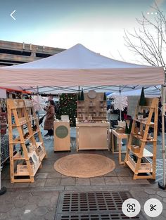 a group of wooden shelves under a white tent