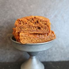 two pieces of cake sitting on top of a metal bowl