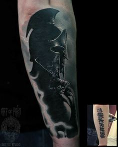 a man's arm with a black and grey tattoo on it