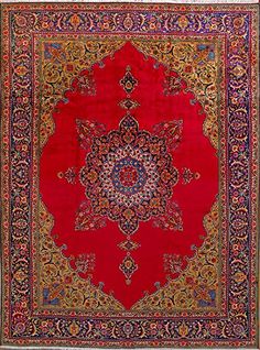 a red rug with an intricate design on the center and sides, in various colors