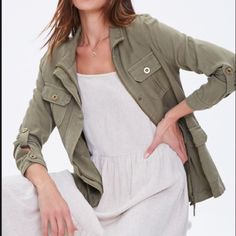 *Brand New* Forever 21 - Longline Drawstring Cargo Jacket Olive Green A Lightweight Woven Cargo Jacket Featuring Funnel Neck, Zip Closure Concealed By A Snap-Button Placket, Burnished Button Closures At The Pleated Patch Flap Pockets And Long Roll-Tab Sleeves, Seamed Detailing, Drawstring Waist, And A Longline Fit. - 100% Lyocell - Machine Wash Cold - Never Been Worn Casual Khaki Outerwear For Day Out, Olive Utility Jacket For Spring, Olive Spring Utility Jacket, Trendy Olive Outerwear For Spring, Forever 21 Long Sleeve Outerwear With Pockets, Olive Utility Outerwear For Spring, Spring Outerwear With Pockets From Forever 21, Forever 21 Casual Long Sleeve Outerwear, Casual Button-up Outerwear By Forever 21