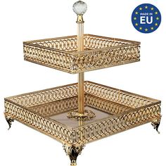 three tiered gold metal tray with glass balls on each side and european eu seal