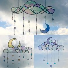 three wind chimes hanging in the sky with clouds and crescents attached to them