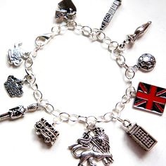 This charm bracelet features London inspired Tibetan silver charms (nickel free). The charms are attached to a silver tone 7.5 inches chain bracelet. Cheap Nickel-free Spiritual Charm Bracelet, Nickel Free Silver Themed Charms, Nickel-free Silver Themed Charms, Nickel-free Themed Silver Charms, Themed Silver Metal Charms, Symbolic Metal Charm Bracelet With Dangling Charms, Symbolic Charm Bracelet With Dangling Charms, Silver Symbolic Bracelets With Dangling Charms, Symbolic Silver Bracelets With Dangling Charms