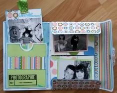 an open scrapbook with photos inside on a wooden floor