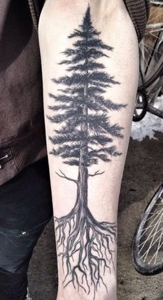 a man with a tree tattoo on his arm