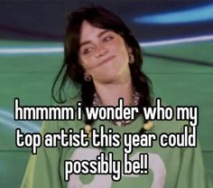 a woman with long hair wearing a green shirt that says mmmm i wonder who my top artist this year could possibly be