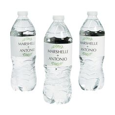 three bottled water bottles with labels on them