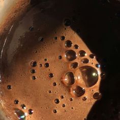 the oil in the pan is brown and has many small bubbles on it's surface