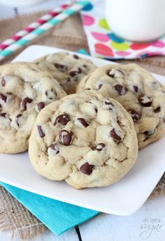 several chocolate chip cookies on a white plate