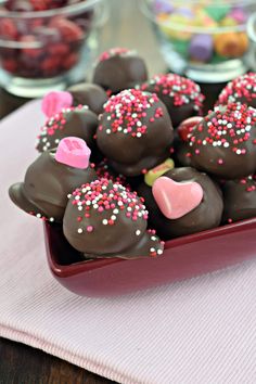 there are many heart shaped chocolates in the bowl