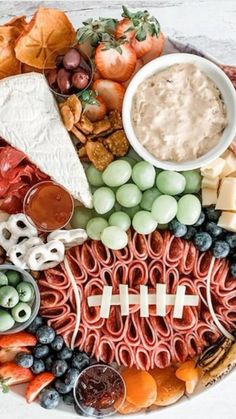 a football themed platter with cheese, meats and fruit