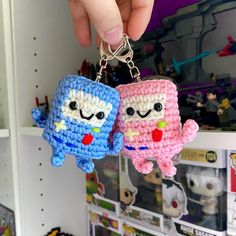 two small crocheted characters are hanging from a keychain