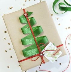 a present wrapped in brown paper with green ribbon