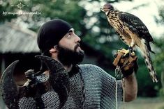 a man with a falcon on his arm and an eagle on his gloved hand