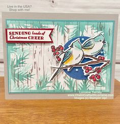 a christmas card with two birds on a branch and the words sending loads of christmas cheer