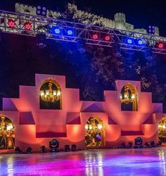 the stage is lit up with colorful lights