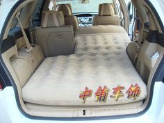 an inflatable mattress is placed inside the back of a car