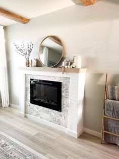 a living room with a fireplace and mirror