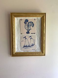 a painting hanging on the wall above a toilet in a room with white walls and gold trim