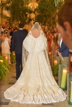 the bride and groom are walking down the aisle